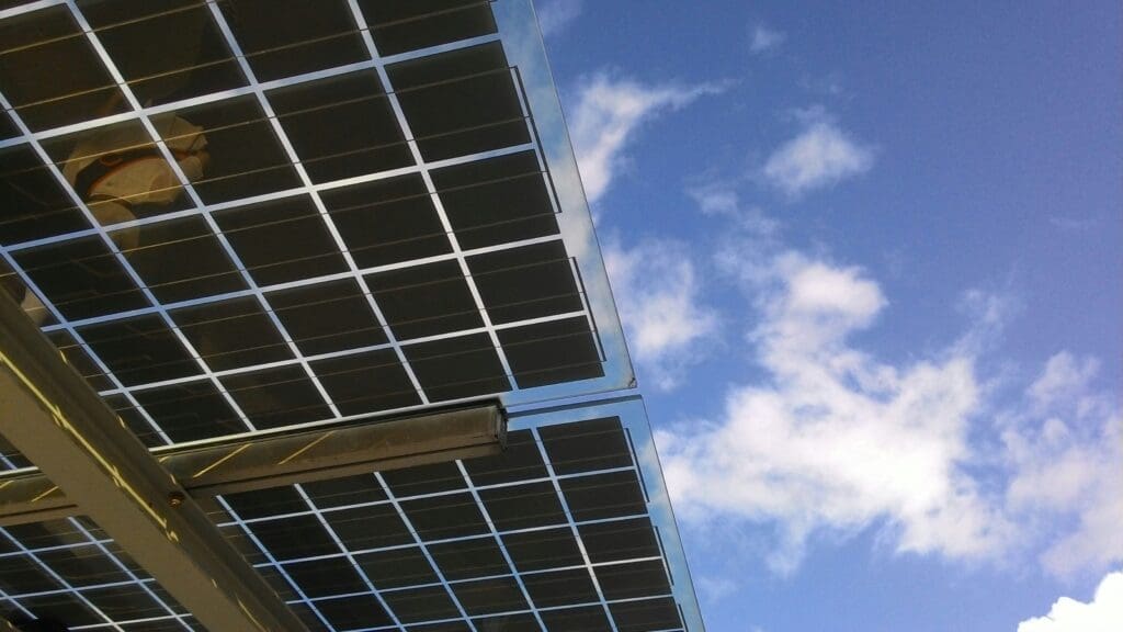 Close-up of solar panels against a clear blue sky, highlighting sustainability.