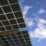 Close-up of solar panels against a clear blue sky, highlighting sustainability.